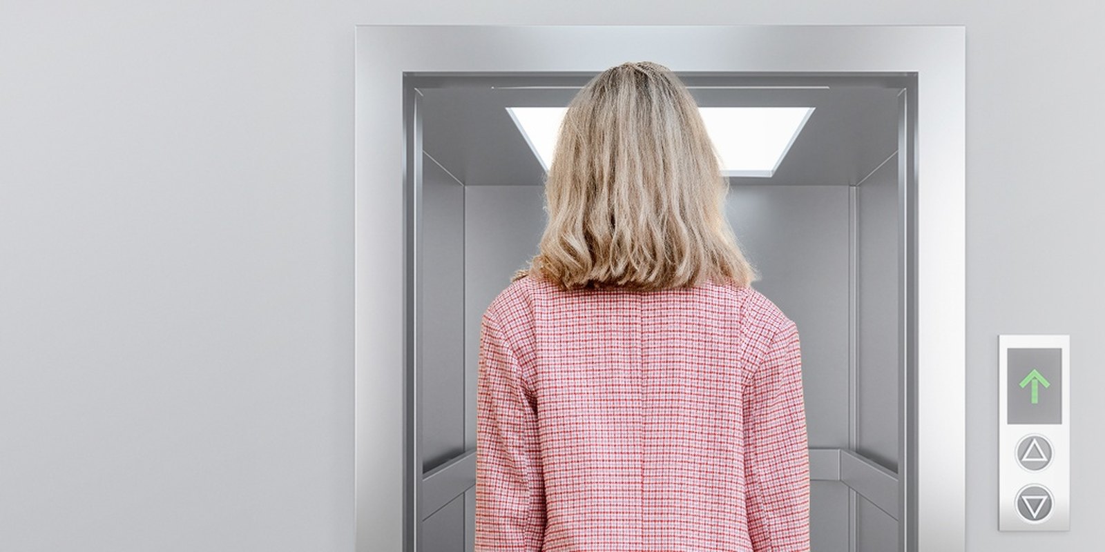 Resident waiting at a lift controlled by an Akuvox EC33