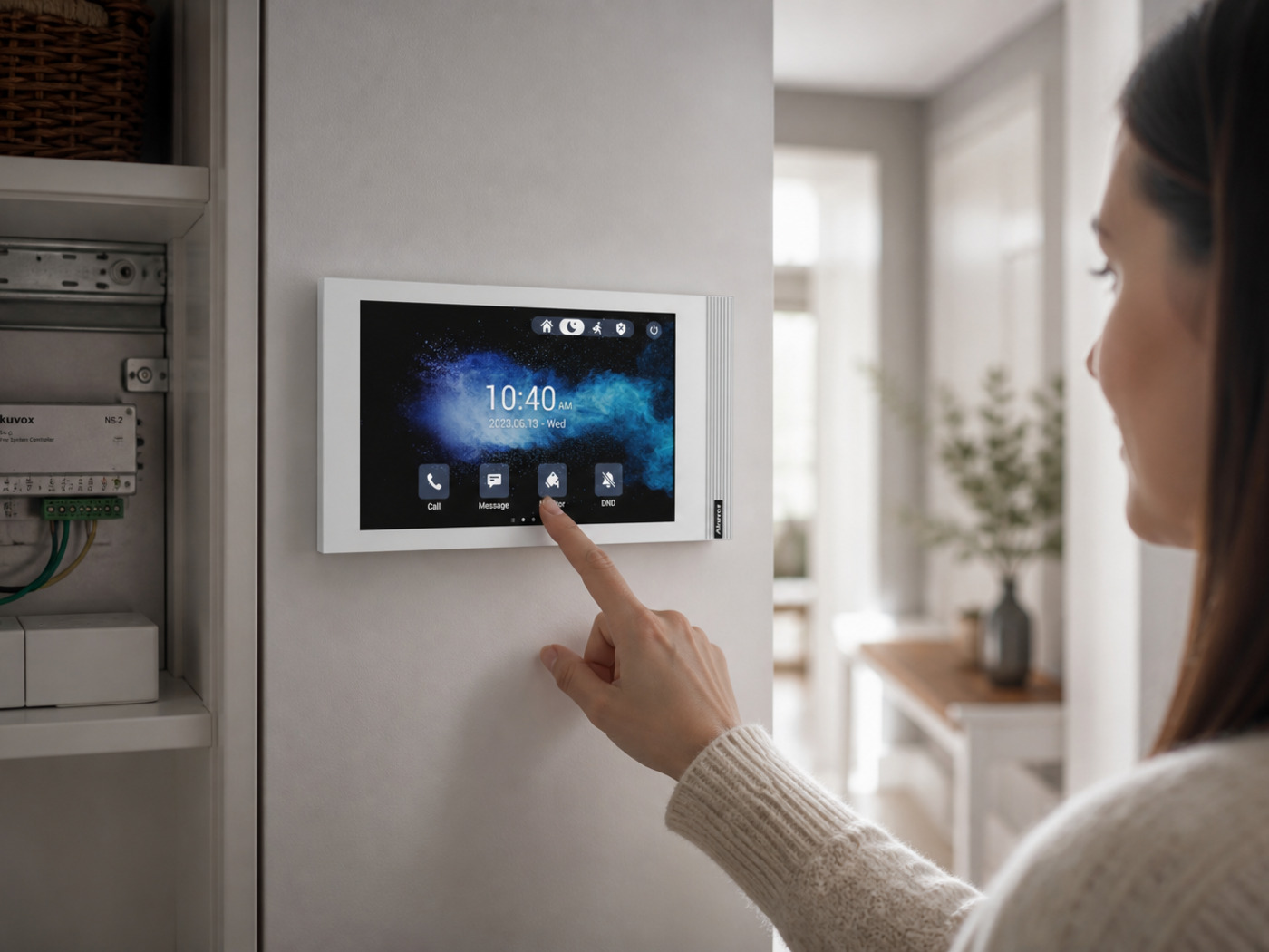 Resident answering a visitor on an Akuvox indoor monitor powered from a 2-wire plant