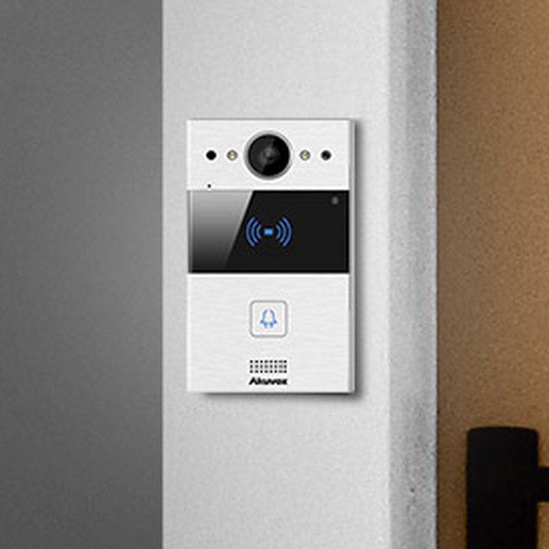 Akuvox 2-wire door phone installed beside an apartment entrance door