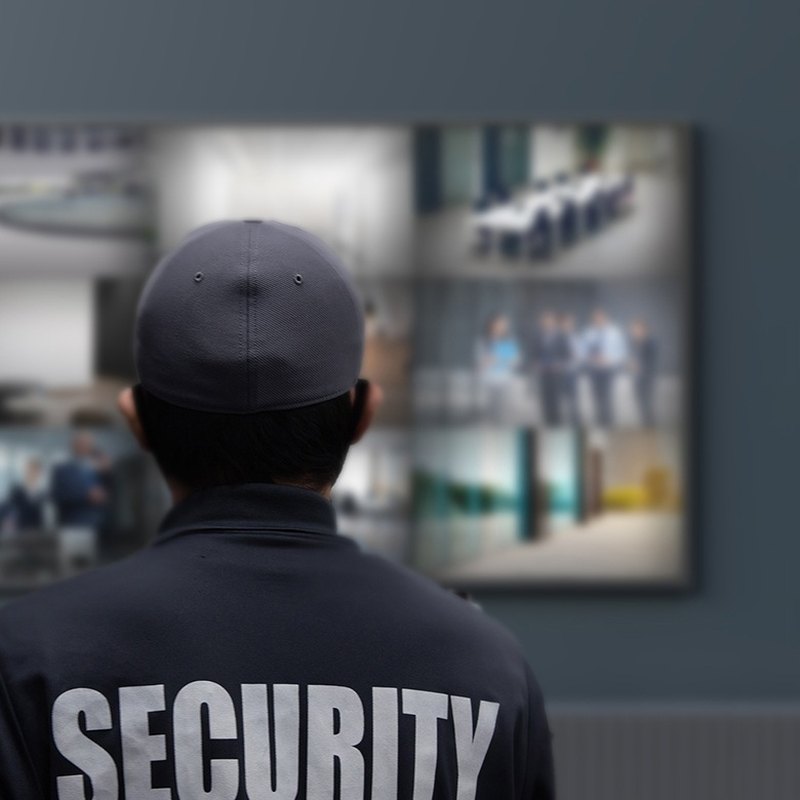 Security guard watching camera feeds with an Akuvox guard unit