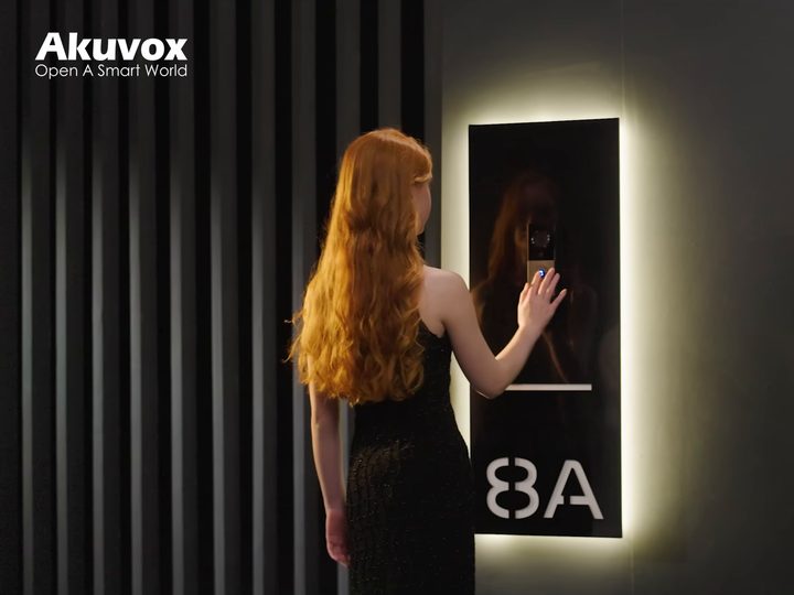 Visitor pressing an Akuvox door station at night
