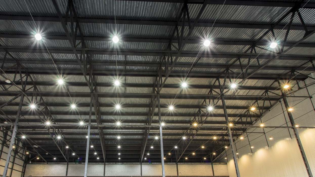 Warehouse lit by rows of round LED high bay lights