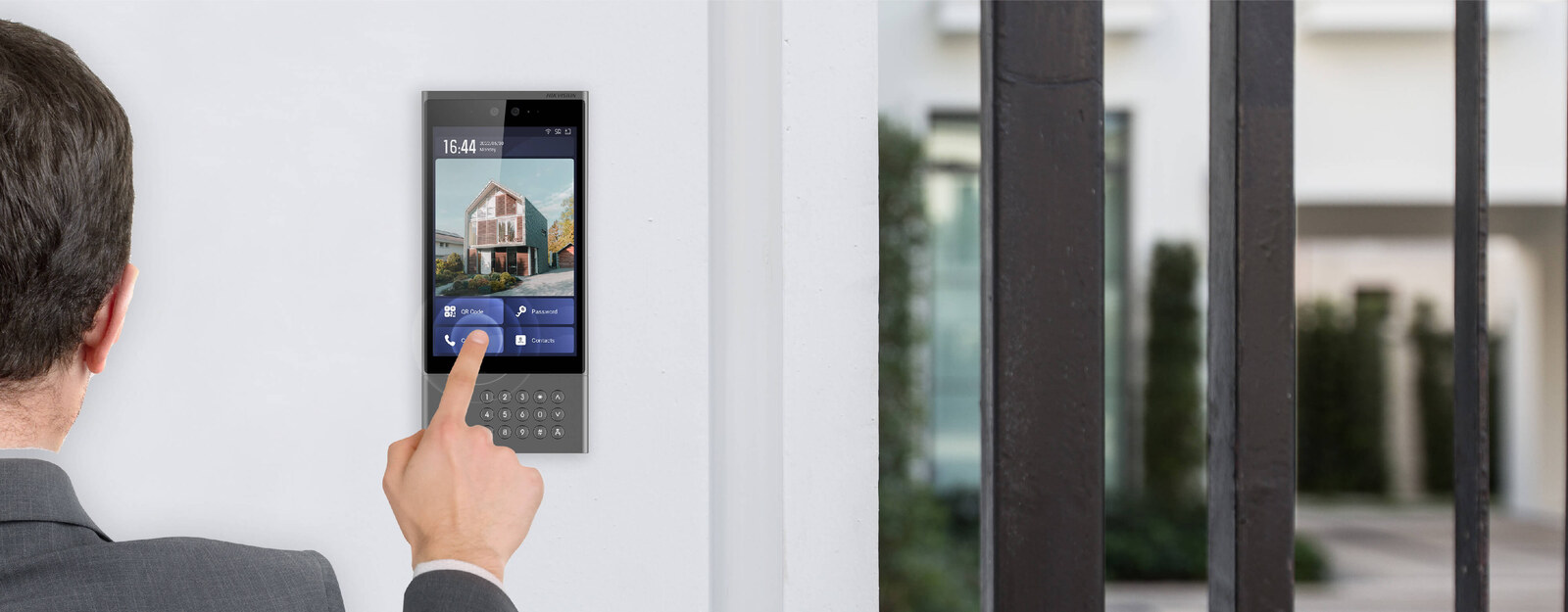 Visitor pressing the call button on a Hikvision DS-KV6113-WPE1 villa door station at a modern Australian front door