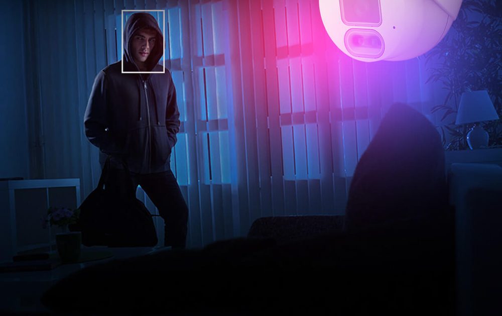 IVSEC dome camera flashing red and blue strobe lights at an intruder in a living room