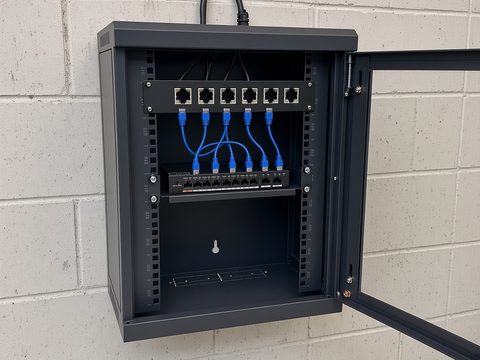 Wall-mounted data cabinet with patch panel