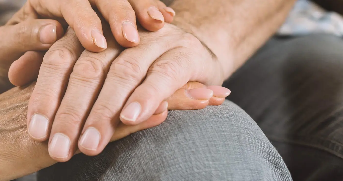 Older couple holding hands