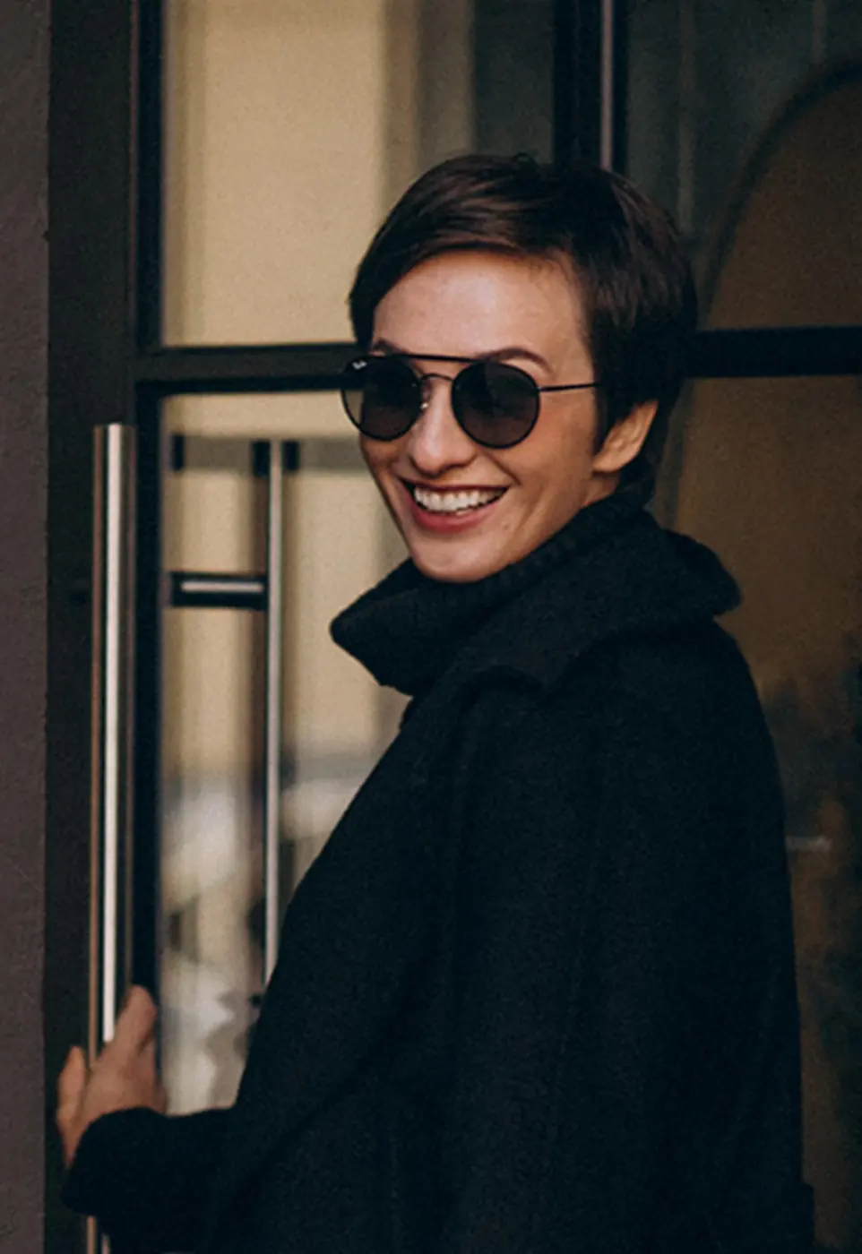 Smiling visitor arriving at a front door