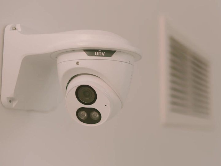 Uniarch Tri-Guard turret on a wall bracket under the eaves