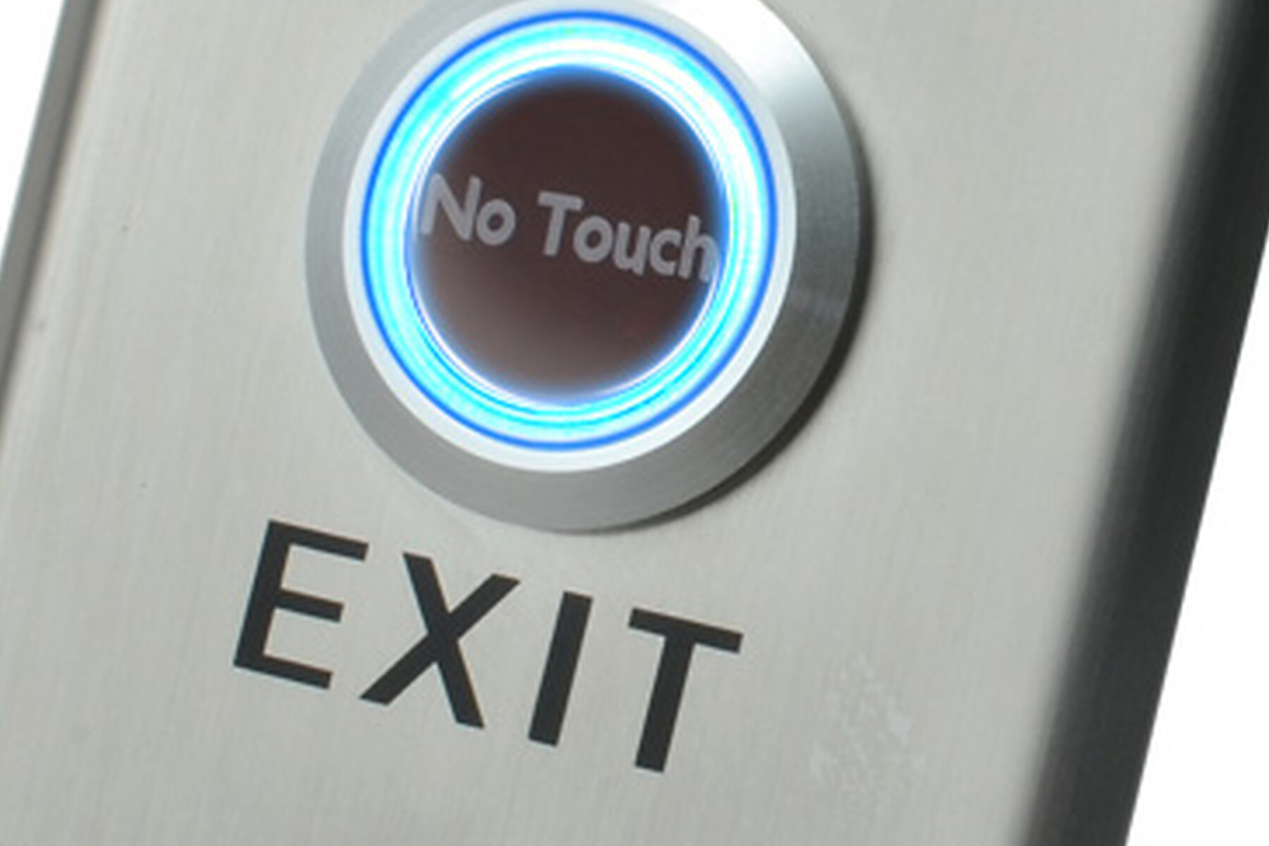 Macro close-up of the X2-EXIT-006 brushed 304 stainless steel finish showing the polished bezel of the No-Touch infrared sensor ring, the recessed sensor disc and the EXIT engraving beneath it